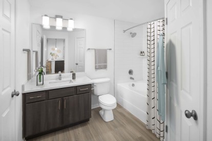 Renovated bathroom with white quartz countertops at Camden Panther Creek apartments in Frisco, Tx