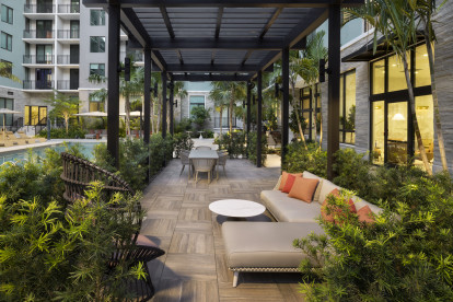 Pool lounge area at Camden Atlantic apartments in Plantation, Florida.