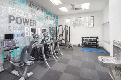 24-hour fitness center with strength and cardio machines, free weights, and a water bottle filling station at Camden Gaines Ranch apartments in Austin, TX