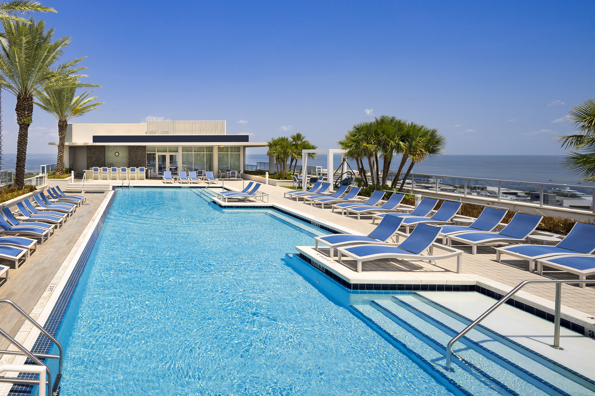 Rooftop pool overlooking Tampa Bay at Camden Pier District apartments in St. Petersburg, Florida.