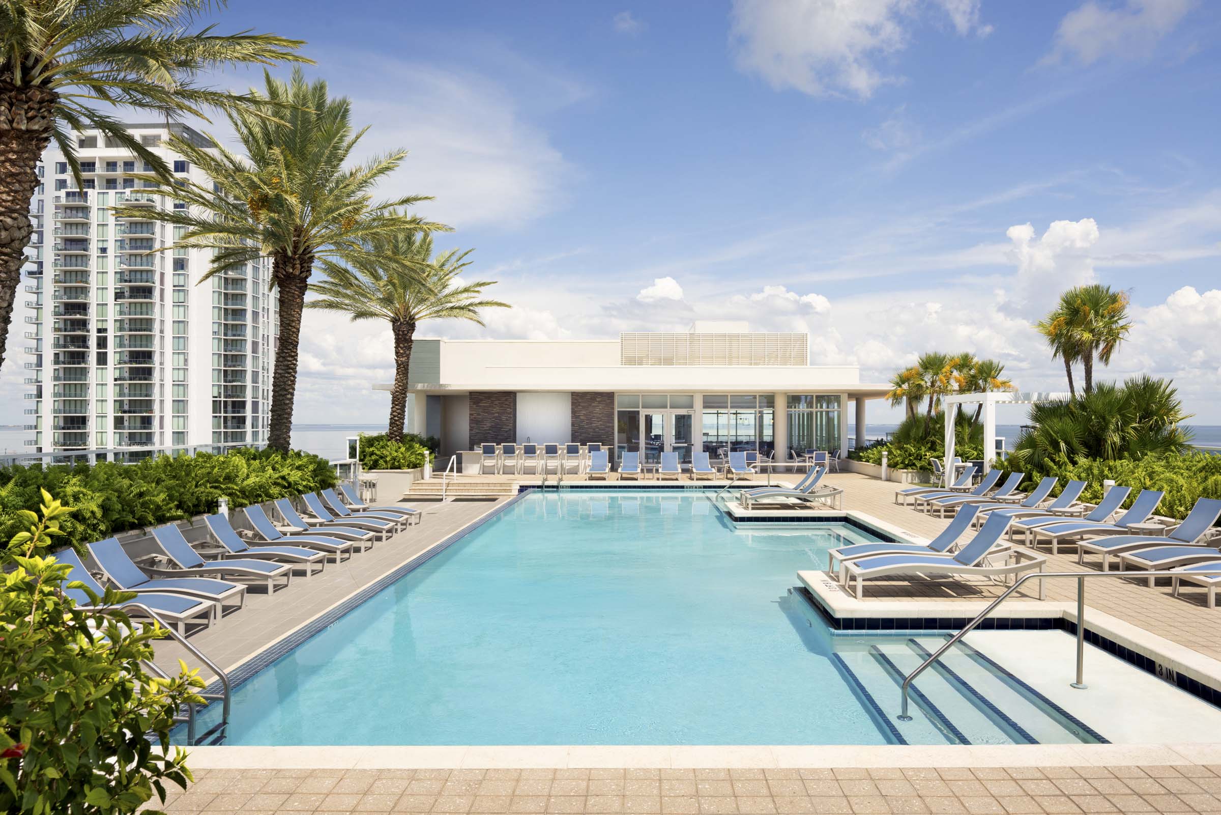 Rooftop pool overlooking Tampa Bay at Camden Pier District apartments in St. Petersburg, Florida.