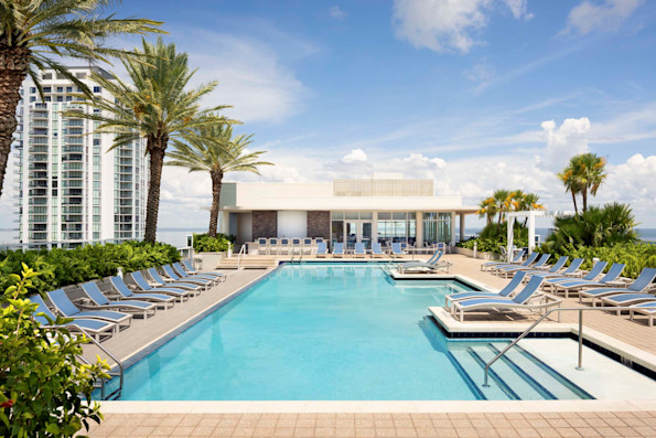 Rooftop pool overlooking Tampa Bay at Camden Pier District apartments in St. Petersburg, Florida.