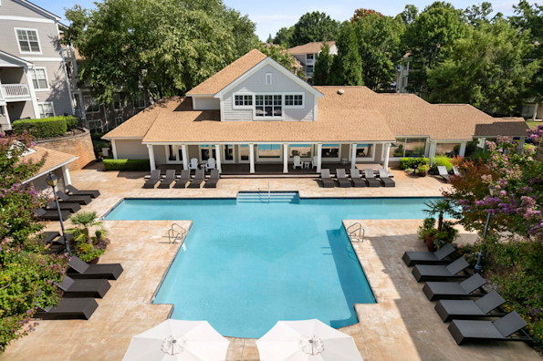 Resort-style swimming pool next to the resident lounge at Camden Sedgebrook apartments in Huntersville, NC