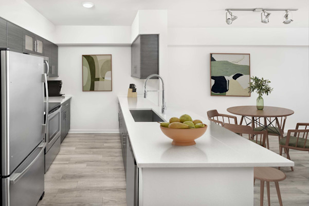 Open concept kitchen and dining in the studio apartment floorplan at Camden Las Olas in Fort Lauderdale, FL.