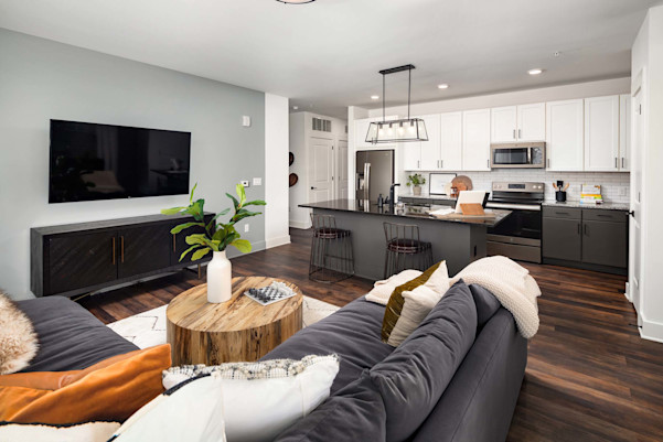 Living room and kitchen with wood-style flooring at Camden West Nashville apartments in Nashville, TN