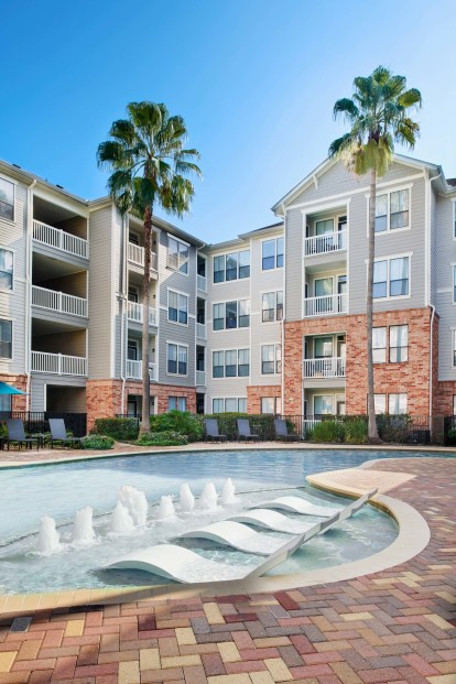 Resort-style swimming pool with Sun Loungers and Tanning Decks at Camden Heights Apartments in Houston, TX