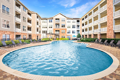 Resort-style swimming pool with Sun Loungers and Tanning Decks at Camden Heights Apartments in Houston, TX