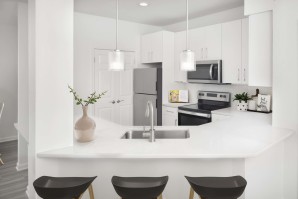 Renovated kitchen with white quartz countertops and stainless steel appliances at Camden St.Clair in Atlanta GA