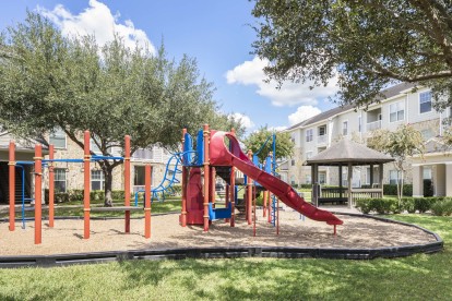 Onsite playground, green space, and picnic seating at Camden Downs at Cinco Ranch in Katy, TX. 