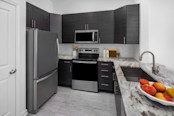 Kitchen with stainless steel appliances and granite countertops at Camden Dulles Station apartments in Herndon, VA