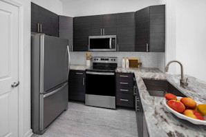 Kitchen with stainless steel appliances and granite countertops at Camden Dulles Station apartments in Herndon, VA