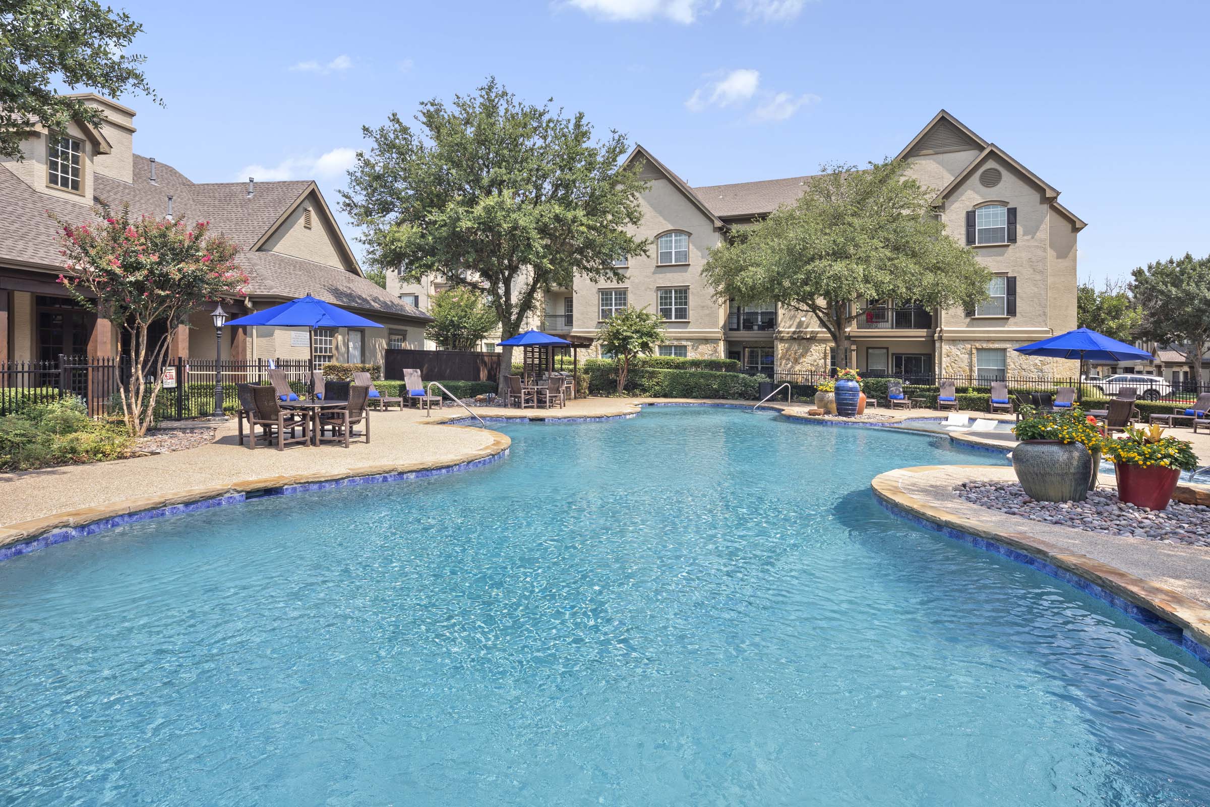 Second pool sundeck with umbrellas and seating areas