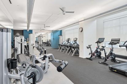 24-hour fitness center with cardio and strength training equipment