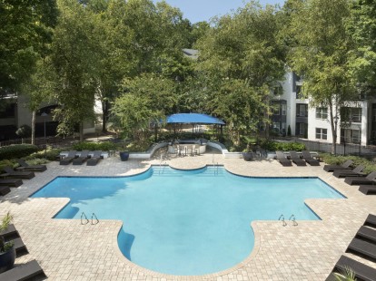 Resort style pool with outdoor cooking and dining area at Camden Phipps in Atlanta, GA