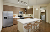 Kitchen and laundry with island white quartz countertops and stainless steel appliances