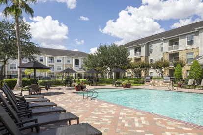 Outdoor grills, dining areas, and sun loungers at Camden Downs at Cinco Ranch in Katy, TX.