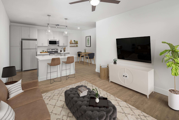 Flats one bedroom living room and kitchen with wood-style flooring and gray cabinets at Camden Greenville