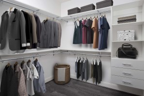 Modern gray closet with built-in shelving and drawers