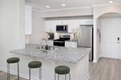 Modern kitchen with white cabinetry and granite countertops at Camden Midtown Atlanta in Atlanta, GA