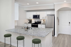 Modern kitchen with white cabinetry and granite countertops at Camden Midtown Atlanta in Atlanta, GA