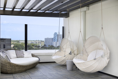 Eighth-Floor Rooftop Terrace swinging chairs at Camden Central apartments in St. Petersburg, Florida.