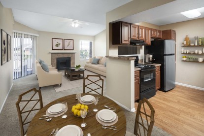 Kitchen dining and living room with sliding glass doors to private balcony