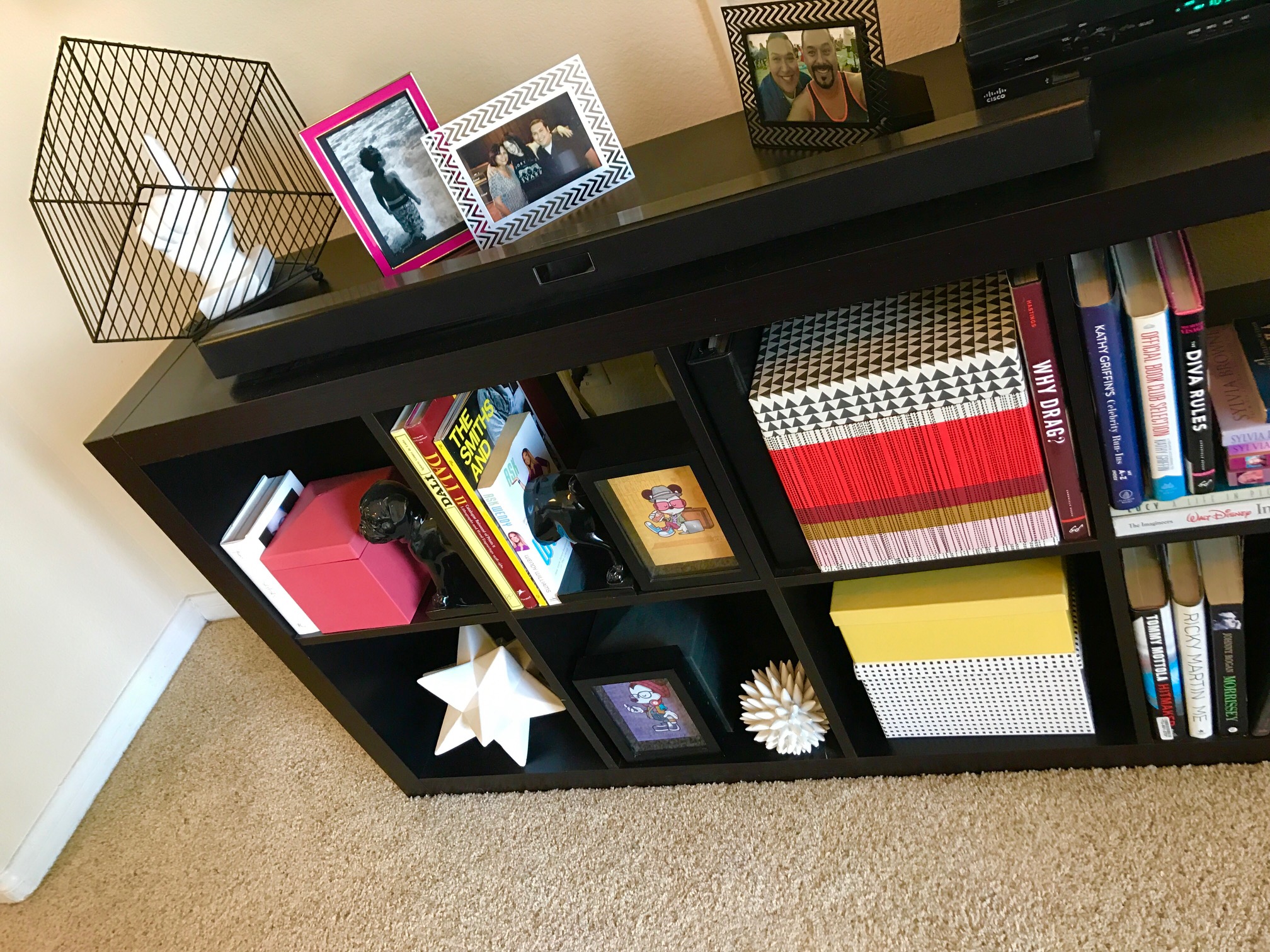 My Camden Apartment - Pops of color in my book shelf highlight some of the colors found in my pillows and art pieces