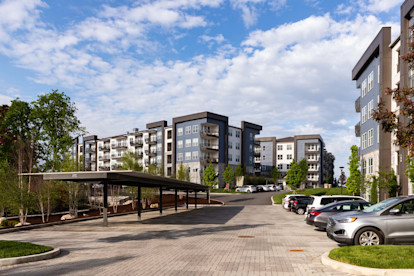 Covered parking spaces across from buildings at Camden West Nashville apartments in Nashville, TN