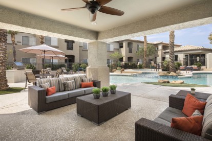 Outdoor lounge with seating areas and ceiling fan