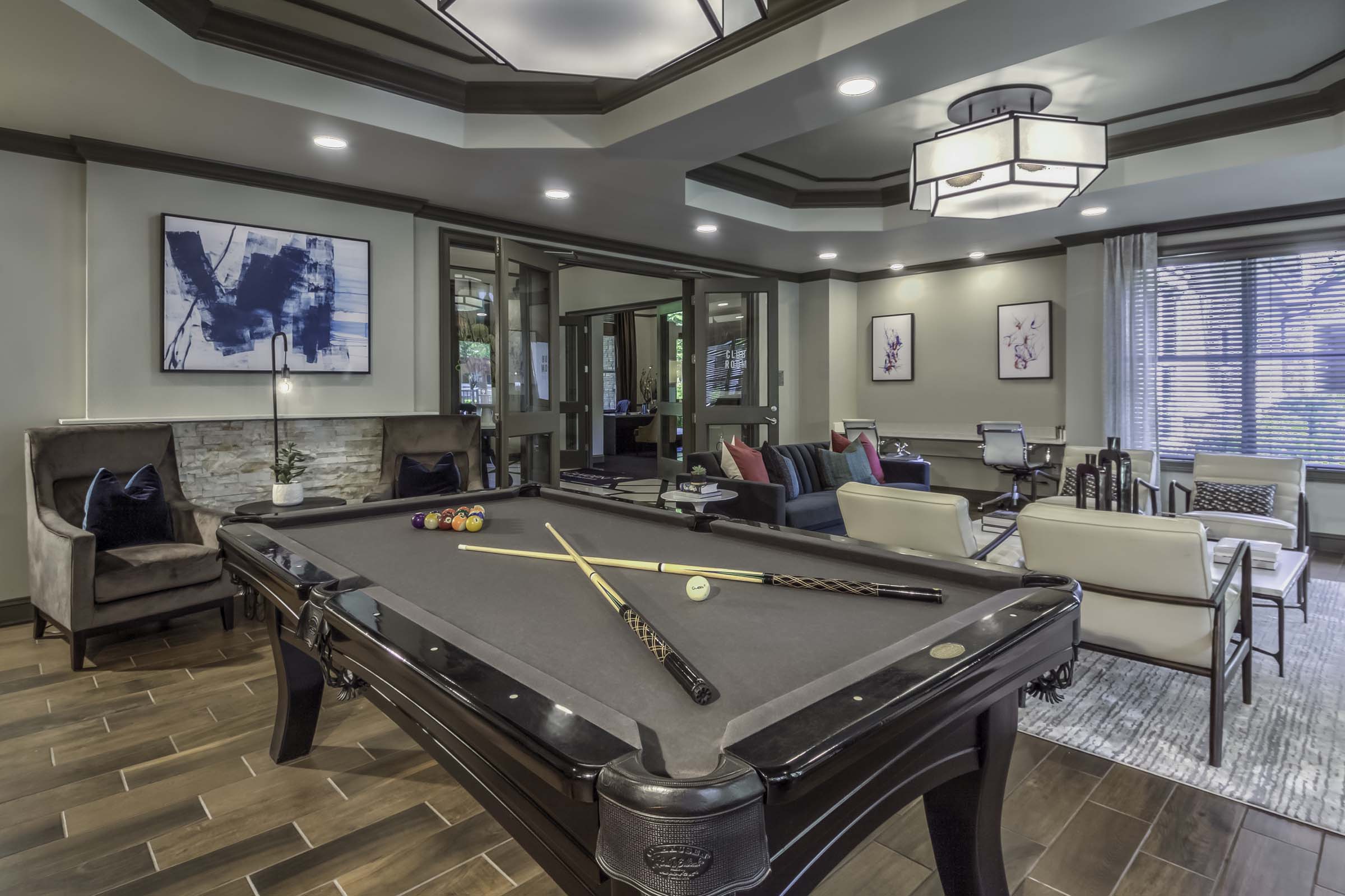 Modern resident lounge with a billards table and entertaining space at Camden Asbury Village in Raleigh, NC