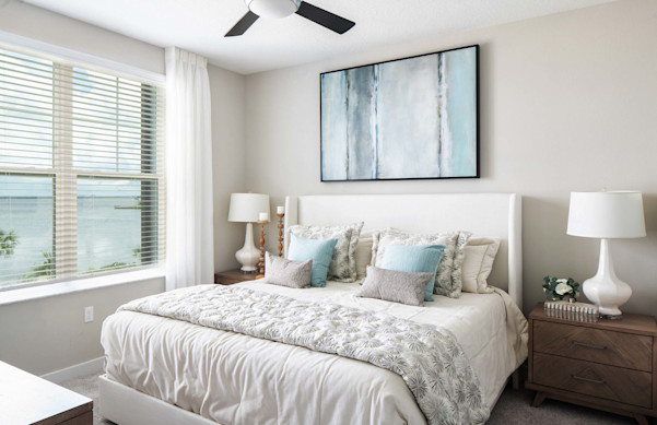 Primary bedroom with ceiling fan and view of the bay at Camden Clearwater apartments in Clearwater, FL