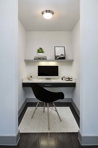 The terrace with a built-in desk area to work from home with wood shelving and a white quartz countertop