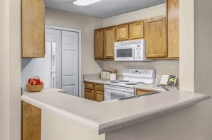 Kitchen with laminate countertops and white appliances