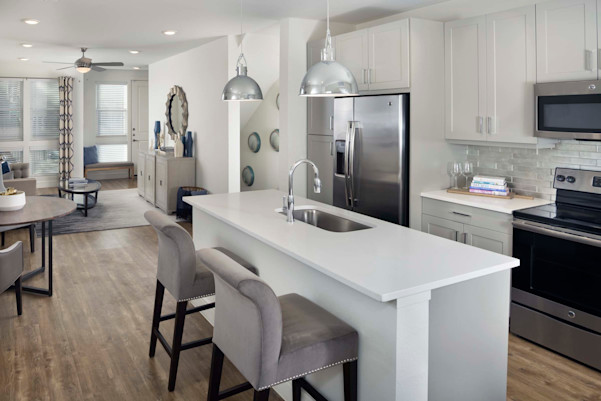 Villas Townhome kitchen and living room showing stairs down to private garage
