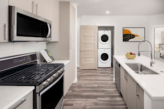 Kitchen at Camden Washingtonian apartments in Gaithersburg, MD features soft-close cabinetry and gas ranges