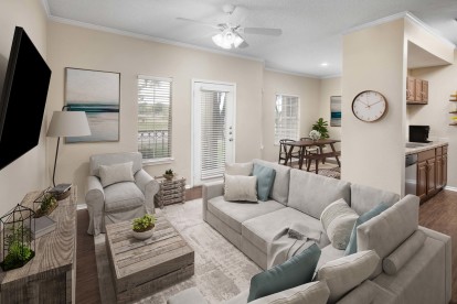 Living room with wood-style floors throughout at Camden Cimarron