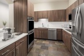 Luxury kitchen with stainless steel appliances and double oven at Camden Post Oak high-rise apartment homes in Houston, TX