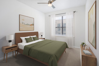 Modern finish bedroom with ceiling fan and plush carpet at Camden Travis Street Apartments in Midtown Houston, Tx