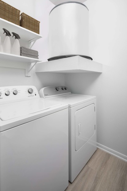 Washer and dryer with built-in laundry room shelves at Camden Panther Creek apartments in Frisco, Tx