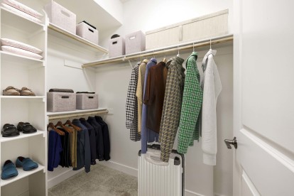 Spacious walk-in closet with wood shelves and rods