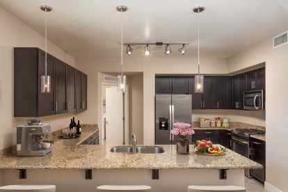 Kitchen with granite countertops gas cooktop and stainless steel appliances