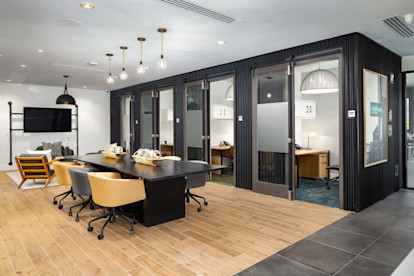 Community workspace with individual co-work office spaces at Camden West Nashville apartments in Nashville, TN