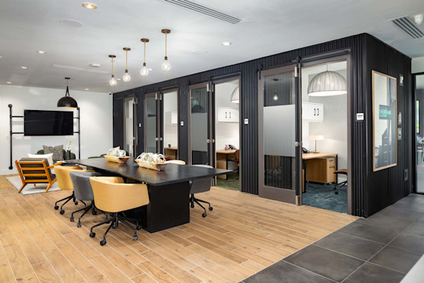 Community workspace with individual co-work office spaces at Camden West Nashville apartments in Nashville, TN
