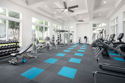 Fitness center with cardio equipment and free weights at Camden Northpointe Apartments in Tomball, TX