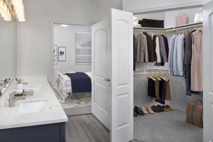 Large walk-in closet in bathroom with double sink vanity at Camden LaVina apartments in Orlando.