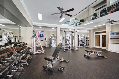 Two-story fitness center with free weights and cardio equipment at Camden Greenway Apartments in Houston, TX