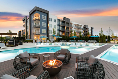 Firepit and seating on the deck in the middle of the pool at twilight at Camden West Nashville apartments in Nashville, TN