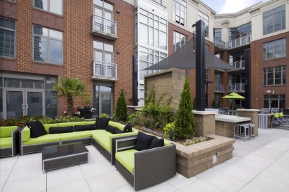 Rooftop outdoor lounge with comfortable seating and views of uptown charlotte