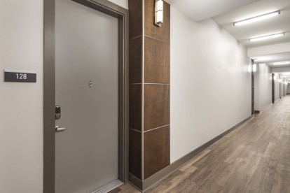 Interior, climate-controlled hallway with front doors at Camden Henderson