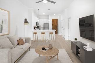 Modern finish with open concept floor plan, breakfast bar and hardwood-style flooring throughout in Camden Travis Street Apartments in Midtown Houston, Tx